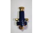A Hemmens attenuator valve clearly showing the lower connection for the steam line and the gas inlet and gas outlet connections. The pressure adjustment is made by rotating the knurled know on the top of the valve.